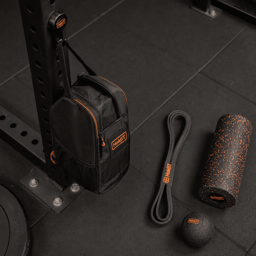 Gym bag on magnetic hook with resistance band, foam roller, and massage ball on a gym mat